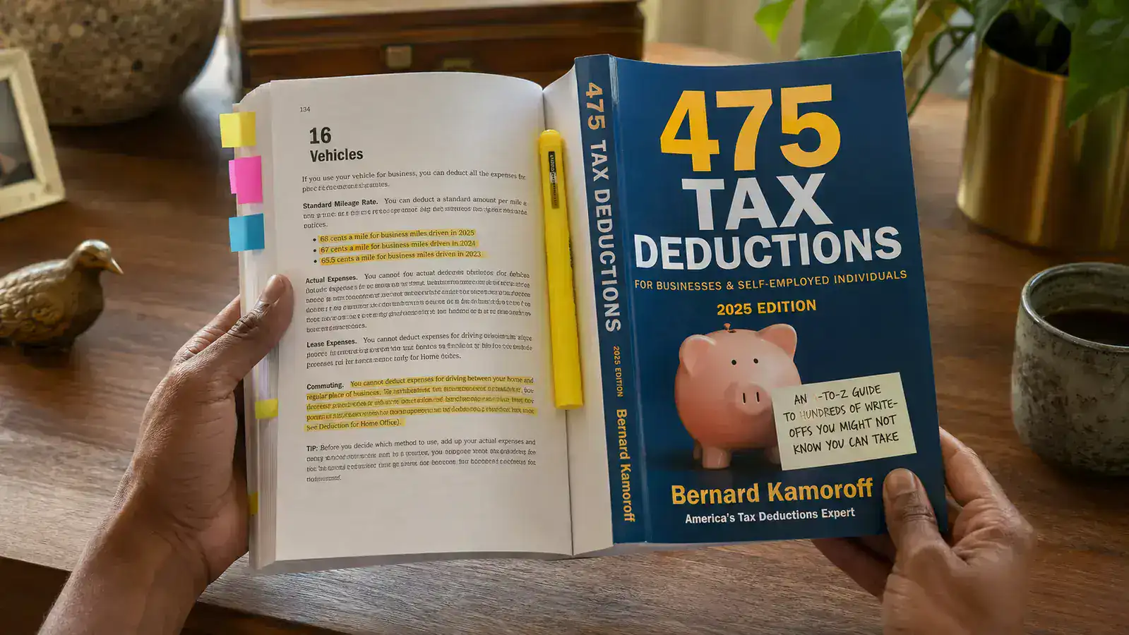 Close-up of a hand holding the 475 Tax Deductions book open to a marked page, with a highlighter resting on the spine